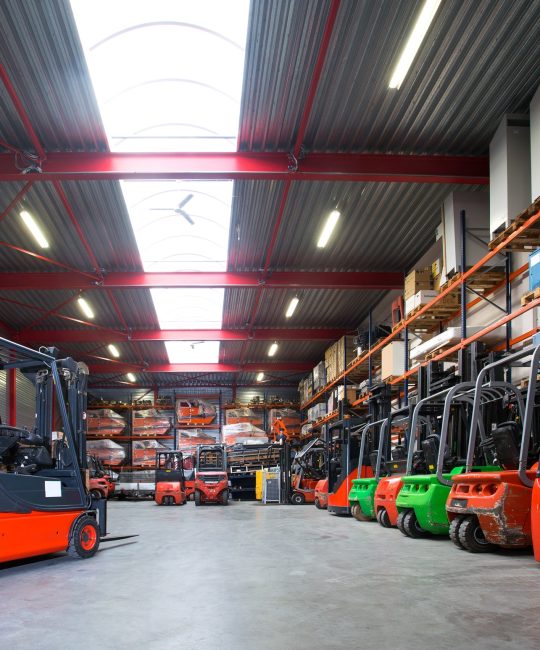 55128,Forklift machinery in a row in warehouse